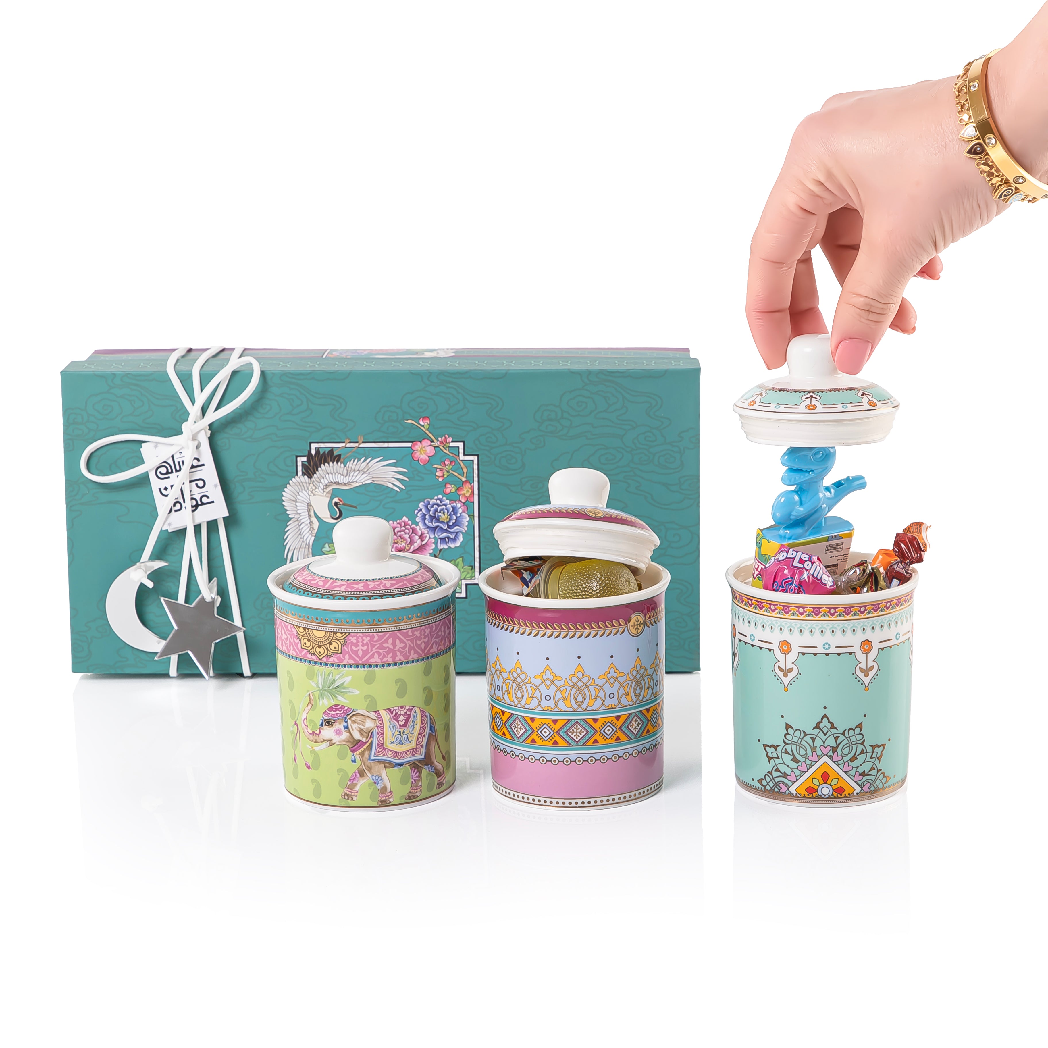 A set of three glasses decorated jars inside a gift box
