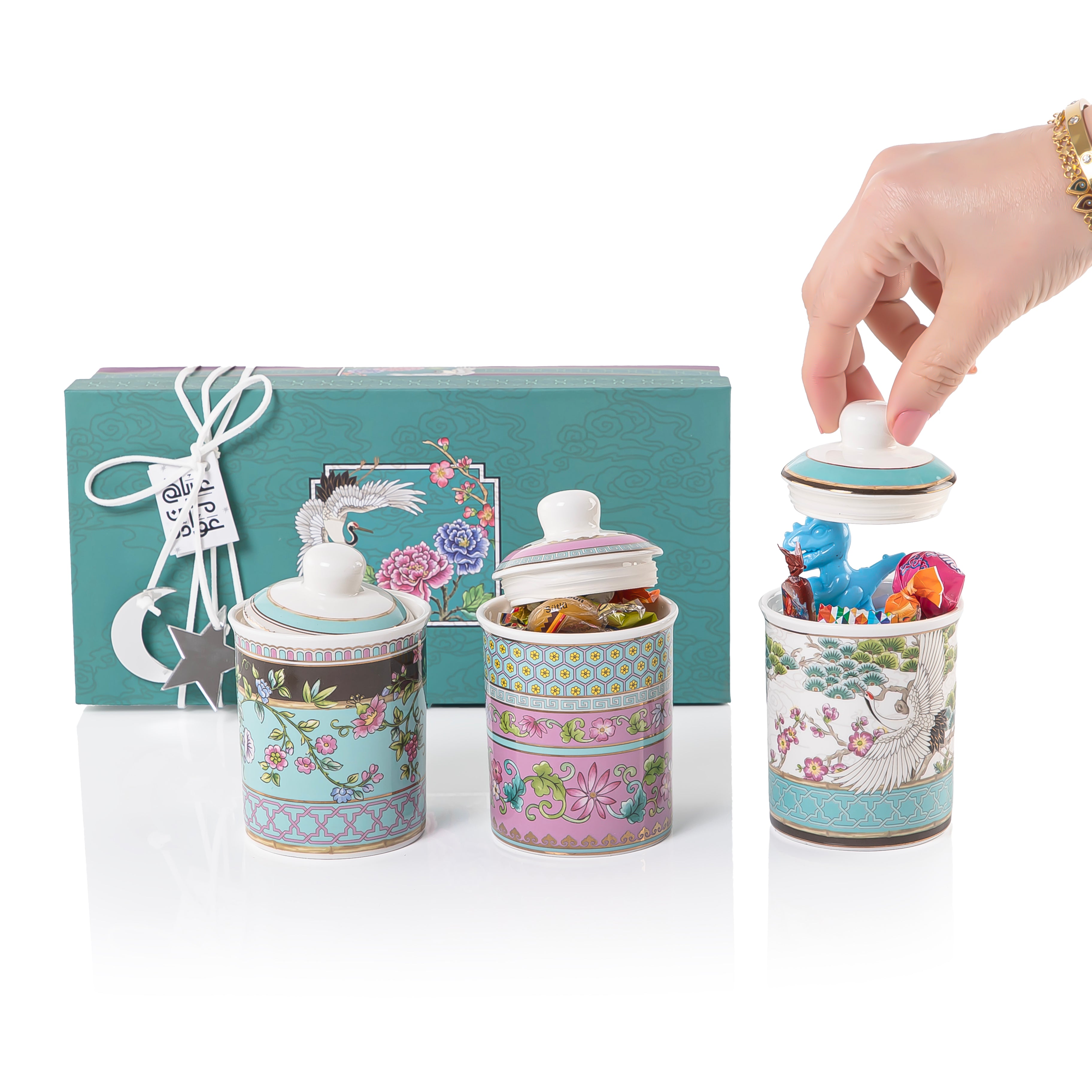 A set of three glasses decorated jars inside a gift box