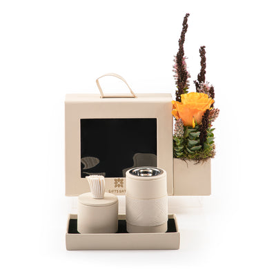 An off-white bag contains incense burner and bakhor jar, decorated with flowers