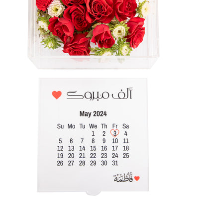 An Acrylic box with calendar and customized name, filled with different types of flowers
