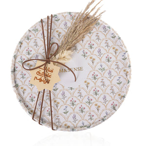 Circular decorated box with a customized name label contains diffuser, candle, and five sticks