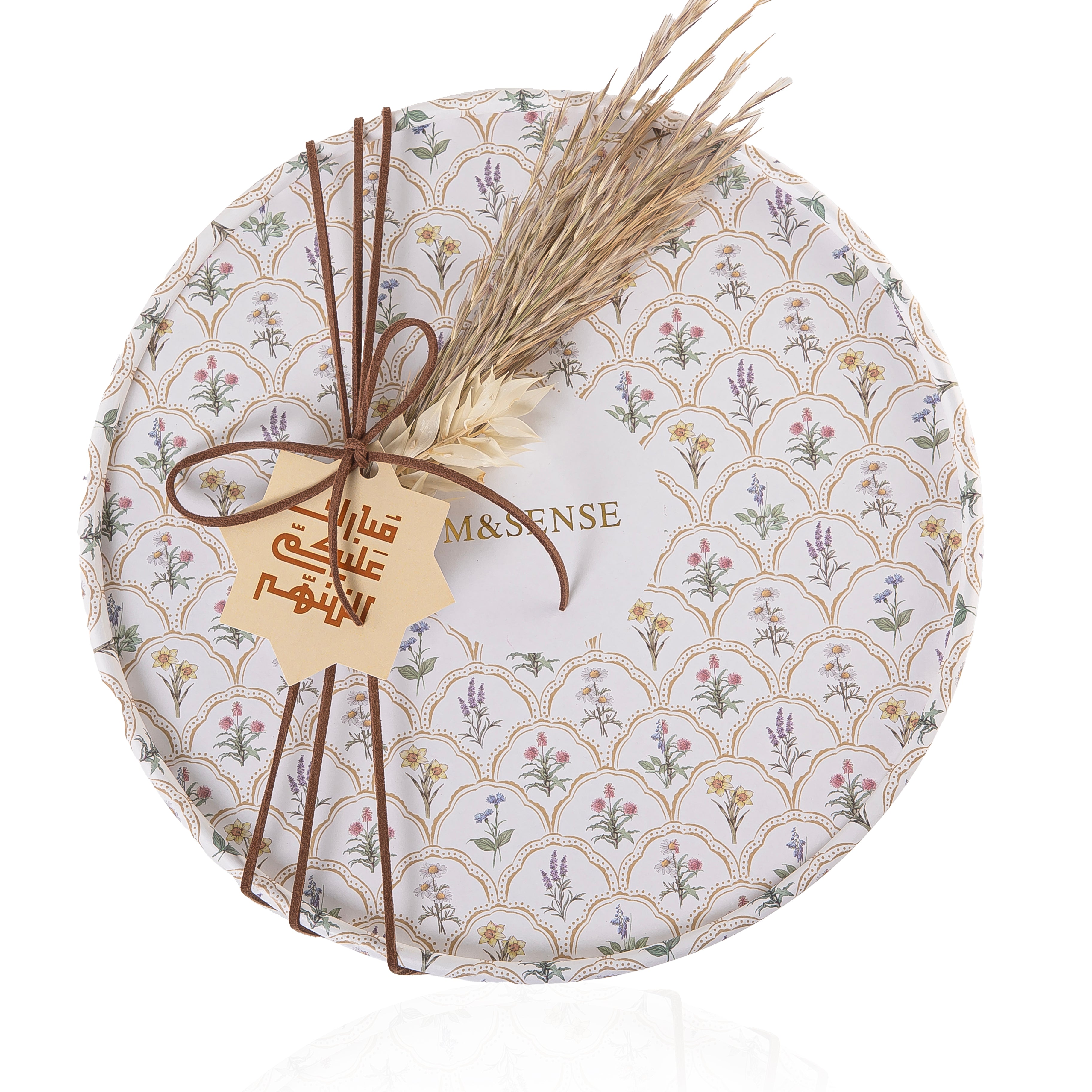 Circular decorated box with a customized name label contains diffuser, candle, and five sticks