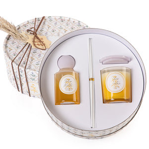 Circular decorated box with a customized name label contains diffuser, candle, and five sticks