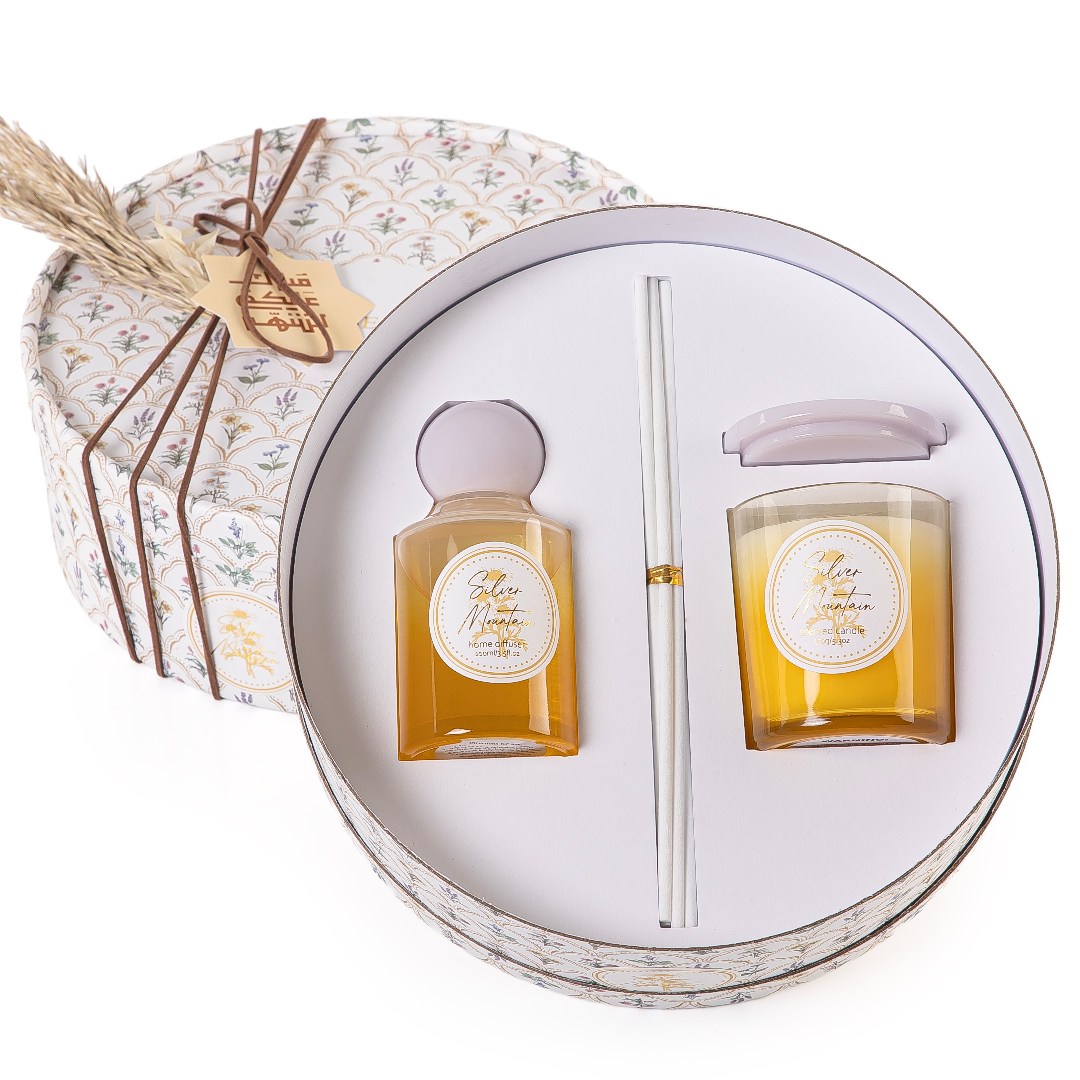 Circular decorated box with a customized name label contains diffuser, candle, and five sticks